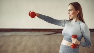Pregnant girl in a gym.